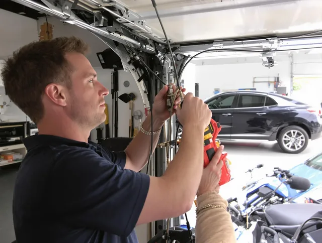 Kennesaw Garage Door Repair safety certified technician performing cable replacement in Kennesaw